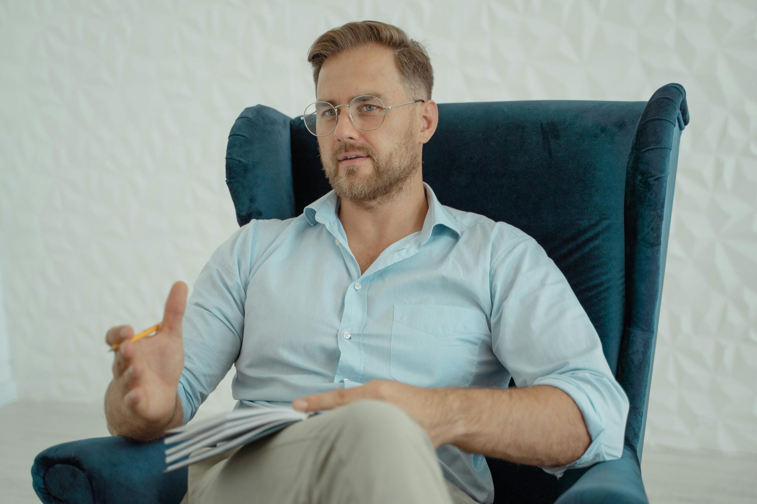 Male therapist sitting in a chair.