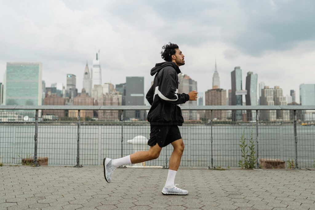 Person running with a city skyline in the background.