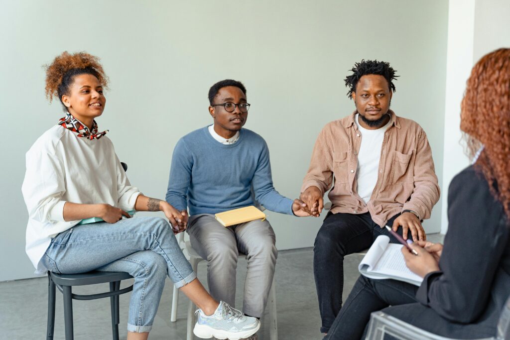 A group therapy session with three people.