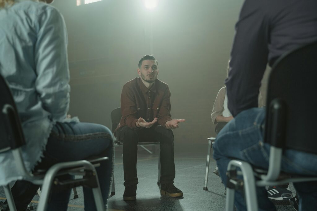 A group therapy session incorporating the 12 steps of recovery.